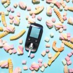 Colorful arrangement of candies and a glucose meter illustrating diabetes management.